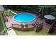 This backyard features an above-ground pool with a slide that creates a relaxing backyard experience at 139 Crown Forest Dr, Mcdonough, GA 30252