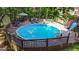 An elevated above-ground pool with wraparound deck overlooks the home's lush outdoor space at 139 Crown Forest Dr, Mcdonough, GA 30252