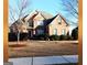 Beautiful two-story brick home with manicured lawn, mature trees, and traditional architectural details at 30 Cynthia Ct, Fayetteville, GA 30215