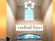 Bright, vaulted foyer showcasing a large window and elegant light fixture at 30 Cynthia Ct, Fayetteville, GA 30215