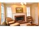 Inviting living room with a brick fireplace, plush seating, and natural light from large windows at 30 Cynthia Ct, Fayetteville, GA 30215