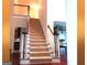 Carpeted staircase featuring wood railings and views into other rooms at 30 Cynthia Ct, Fayetteville, GA 30215