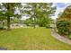 Spacious backyard with mature trees and an attached deck along the back of the brick home at 110 Silver Leaf Dr, Fayetteville, GA 30214