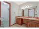 Bright bathroom featuring double vanity, large mirror, and neutral-toned walls and tile at 110 Silver Leaf Dr, Fayetteville, GA 30214