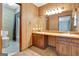 Bathroom showcasing the vanity with dual sinks, a mirror, and a combination tub and shower at 110 Silver Leaf Dr, Fayetteville, GA 30214