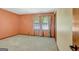 Bedroom with neutral carpeting, a window with floral curtains, and light peach walls at 110 Silver Leaf Dr, Fayetteville, GA 30214