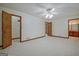 Spacious bedroom with a ceiling fan and multiple doors at 110 Silver Leaf Dr, Fayetteville, GA 30214