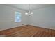 Traditional dining room with hardwood floors, wainscoting, and a classic chandelier at 110 Silver Leaf Dr, Fayetteville, GA 30214