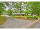 Long driveway leading to a home with a detached garage and a well-maintained front lawn at 110 Silver Leaf Dr, Fayetteville, GA 30214