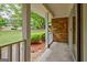 Covered front porch with brick columns providing shelter and a view of the surrounding greenery at 110 Silver Leaf Dr, Fayetteville, GA 30214
