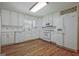Bright kitchen features white appliances, tiled backsplash, and hardwood floors at 110 Silver Leaf Dr, Fayetteville, GA 30214