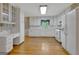 Charming kitchen with white appliances, cabinets, and wood floors at 110 Silver Leaf Dr, Fayetteville, GA 30214