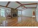 Spacious living room features a stone fireplace, wood beams, and hardwood floors at 110 Silver Leaf Dr, Fayetteville, GA 30214