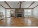 Living room showcasing the fireplace, beautiful hardwood floors, and charming decor at 110 Silver Leaf Dr, Fayetteville, GA 30214