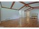 Open living room with hardwood floors, wood beam ceiling, and natural light at 110 Silver Leaf Dr, Fayetteville, GA 30214