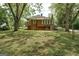 View of the backyard with mature trees and a fenced perimeter at 19 Mcdonough St, Hampton, GA 30228