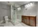 Modern bathroom featuring a glass-enclosed shower, marble floors and a wood vanity at 19 Mcdonough St, Hampton, GA 30228