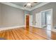 Sun-filled bedroom featuring hardwood floors and multiple doors leading to various spaces at 19 Mcdonough St, Hampton, GA 30228