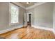 Bedroom featuring hardwood floors, neutral paint, and natural light at 19 Mcdonough St, Hampton, GA 30228