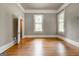 Spacious bedroom features hardwood floors, neutral paint, with plenty of natural light at 19 Mcdonough St, Hampton, GA 30228