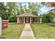 Charming single story house with a quaint front porch and well-manicured lawn at 19 Mcdonough St, Hampton, GA 30228