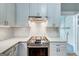 Modern kitchen equipped with a stainless steel range hood and subway tile backsplash at 19 Mcdonough St, Hampton, GA 30228