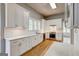 Bright kitchen with white cabinets, subway tile backsplash, and stainless steel appliances at 19 Mcdonough St, Hampton, GA 30228