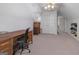 Finished attic space with neutral carpeting, a desk, and storage at 8040 Classic Dr, Jonesboro, GA 30236
