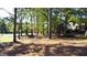A tree-lined backyard provides shade and privacy, perfect for enjoying nature right outside the home at 8040 Classic Dr, Jonesboro, GA 30236