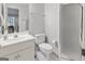 Clean bathroom with white fixtures including a vanity, toilet, and shower stall at 8040 Classic Dr, Jonesboro, GA 30236