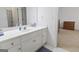 Bathroom featuring a white countertop and cabinets with an attached bedroom and shower at 8040 Classic Dr, Jonesboro, GA 30236