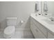 Bathroom features a white countertop, cabinets and toilet with a mirror on the wall at 8040 Classic Dr, Jonesboro, GA 30236