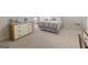 Neutral bedroom with light colored carpet with a wooden dresser with a small sound system at 8040 Classic Dr, Jonesboro, GA 30236