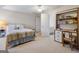 Neutral bedroom with light colored carpet with desk and attached bathroom at 8040 Classic Dr, Jonesboro, GA 30236