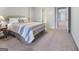 Light-filled bedroom features neutral walls, carpet floors, and an open en-suite bathroom at 8040 Classic Dr, Jonesboro, GA 30236