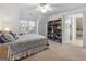 Bright bedroom features natural light, built-in shelving, and an en-suite bathroom at 8040 Classic Dr, Jonesboro, GA 30236