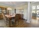 Formal dining room featuring hardwood floors, large windows, and elegant chandelier at 8040 Classic Dr, Jonesboro, GA 30236