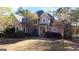 Stately two-story brick home with lush landscaping and a circular driveway at 8040 Classic Dr, Jonesboro, GA 30236
