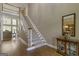 Spacious foyer with hardwood floors, staircase, and transom window over the front door at 8040 Classic Dr, Jonesboro, GA 30236
