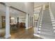 Open foyer with hardwood floors, staircase, and views into the dining room at 8040 Classic Dr, Jonesboro, GA 30236