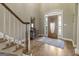 Elegant foyer with hardwood floors, staircase, and decorative front door with side lights at 8040 Classic Dr, Jonesboro, GA 30236