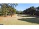 Scenic view of the lush green golf course surrounded by tall pine trees on a sunny day at 8040 Classic Dr, Jonesboro, GA 30236
