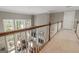 Upper hallway looking over the great room, showcasing hardwood railing and an open view of the home's layout at 8040 Classic Dr, Jonesboro, GA 30236