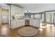 Well-lit kitchen with white cabinets, stainless steel appliances, and hardwood floors at 8040 Classic Dr, Jonesboro, GA 30236