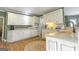 Charming kitchen featuring white cabinetry, modern appliances, and hardwood flooring at 8040 Classic Dr, Jonesboro, GA 30236