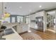 Open-concept kitchen with white cabinetry, stainless appliances, and hardwood flooring at 8040 Classic Dr, Jonesboro, GA 30236