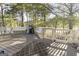 Outdoor patio area with a grill, seating, and wooded views at 8040 Classic Dr, Jonesboro, GA 30236