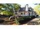 A spacious home featuring a large deck, brick exterior, and beautiful landscaping, perfect for outdoor entertaining at 8040 Classic Dr, Jonesboro, GA 30236
