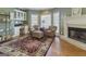 Inviting sitting area with fireplace, comfortable armchairs, and natural light at 8040 Classic Dr, Jonesboro, GA 30236