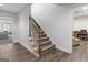 Carpeted staircase with wooden handrail leading to a lower level at 8040 Classic Dr, Jonesboro, GA 30236